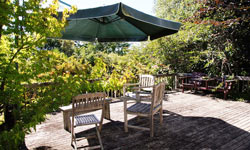 Relax on your Motueka holiday home veranda with a glass of wine.